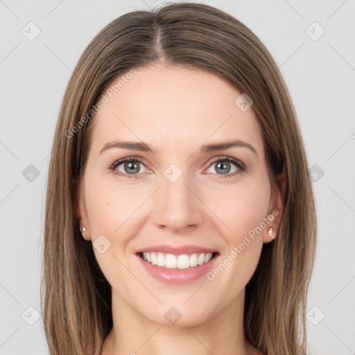 Joyful white young-adult female with long  brown hair and grey eyes