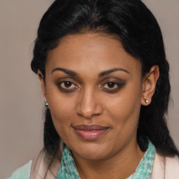 Joyful black adult female with medium  brown hair and brown eyes