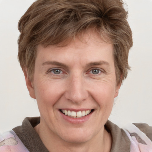 Joyful white adult female with short  brown hair and grey eyes