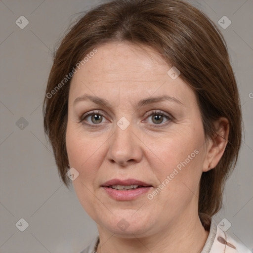 Joyful white adult female with medium  brown hair and grey eyes