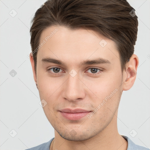 Joyful white young-adult male with short  brown hair and brown eyes