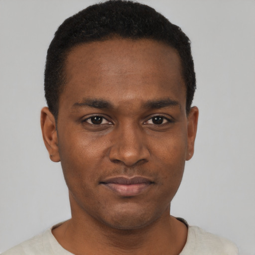 Joyful black young-adult male with short  black hair and brown eyes