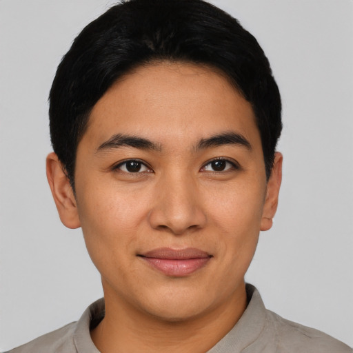 Joyful asian young-adult male with short  black hair and brown eyes