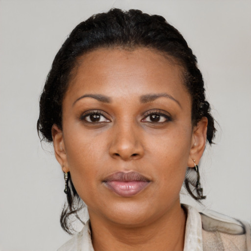 Neutral black young-adult female with medium  brown hair and brown eyes