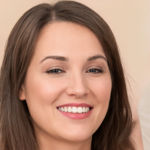 Joyful white young-adult female with long  brown hair and brown eyes