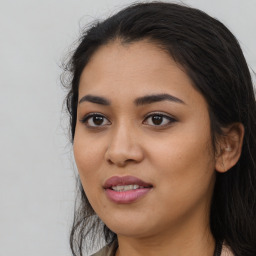 Joyful latino young-adult female with long  black hair and brown eyes