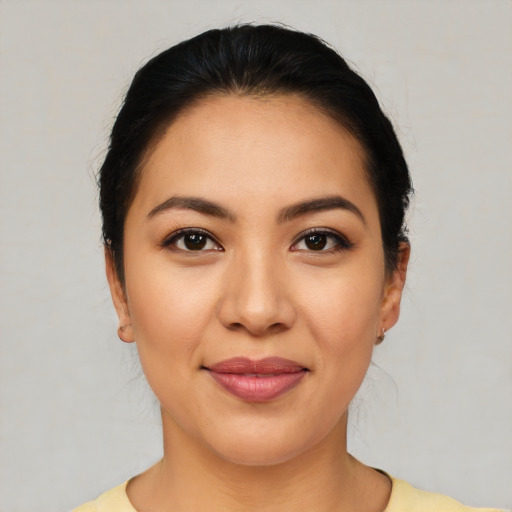 Joyful latino young-adult female with medium  black hair and brown eyes