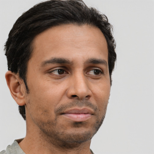 Neutral latino young-adult male with short  brown hair and brown eyes
