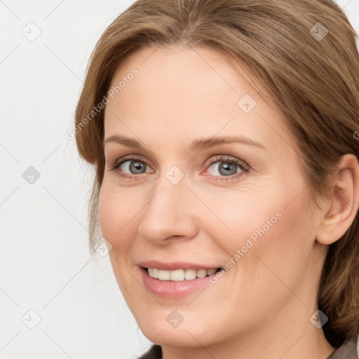 Joyful white young-adult female with medium  brown hair and blue eyes