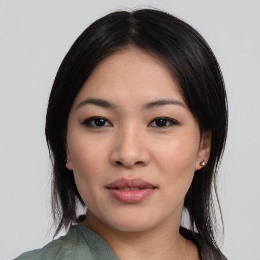 Joyful asian young-adult female with medium  black hair and brown eyes