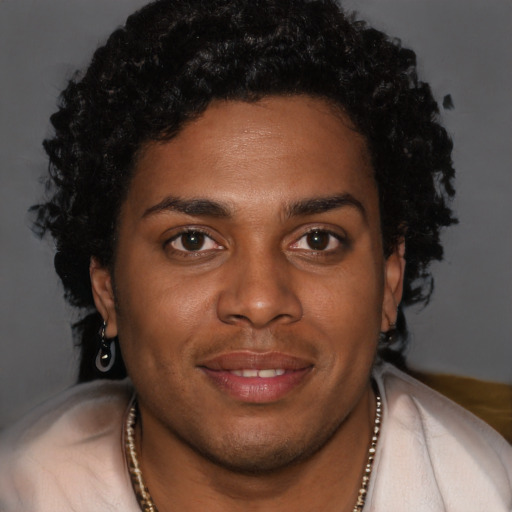 Joyful black young-adult male with short  brown hair and brown eyes