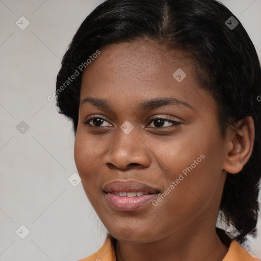 Joyful black young-adult female with short  black hair and brown eyes