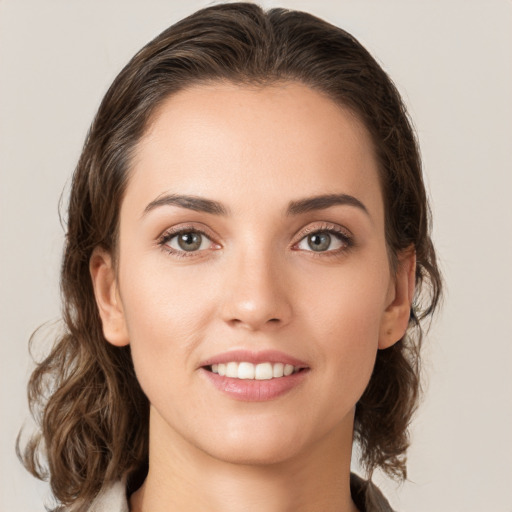 Joyful white young-adult female with medium  brown hair and green eyes