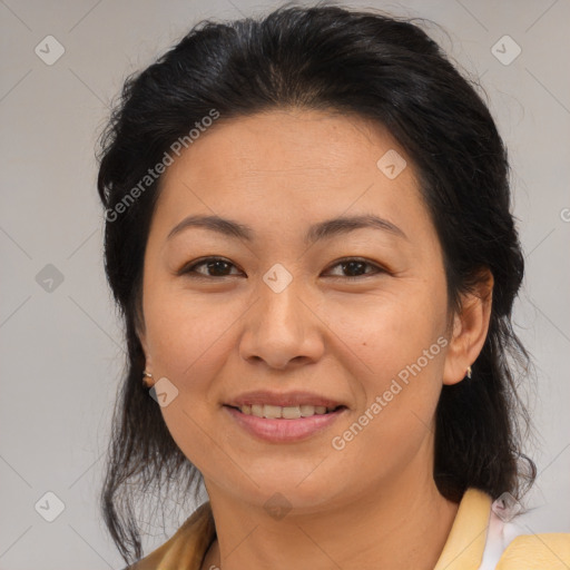 Joyful latino adult female with medium  brown hair and brown eyes