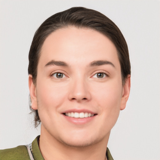 Joyful white young-adult female with short  brown hair and grey eyes