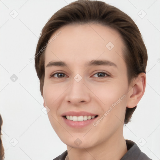 Joyful white young-adult female with short  brown hair and brown eyes