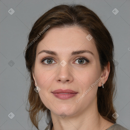 Joyful white young-adult female with medium  brown hair and green eyes