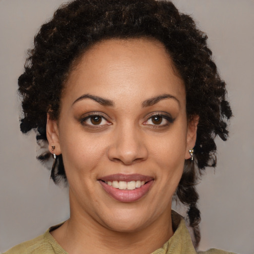 Joyful black young-adult female with medium  brown hair and brown eyes