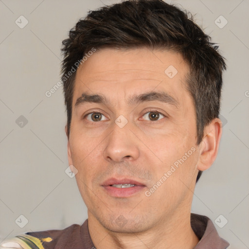 Joyful white adult male with short  black hair and brown eyes