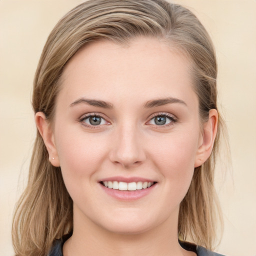 Joyful white young-adult female with long  brown hair and blue eyes