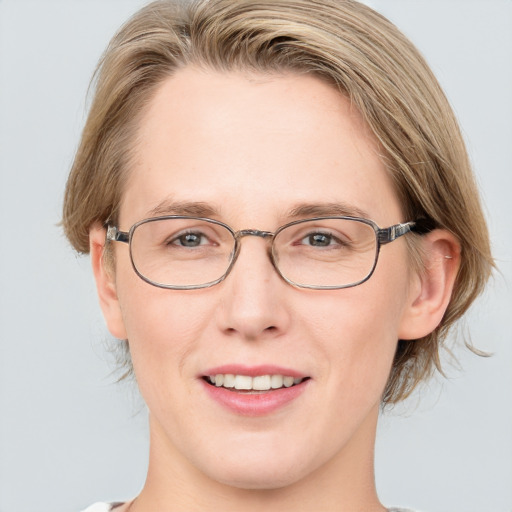 Joyful white adult female with medium  brown hair and blue eyes