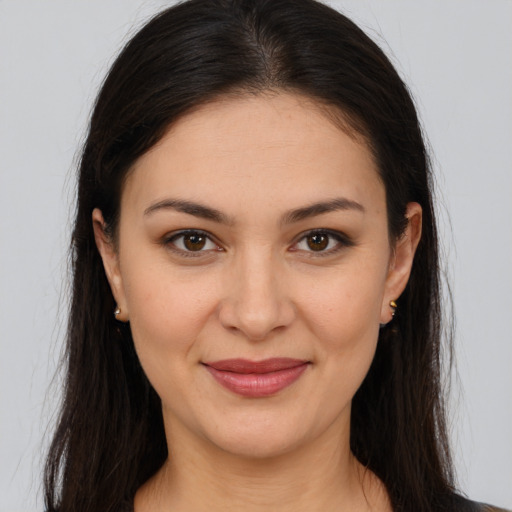 Joyful white young-adult female with long  brown hair and brown eyes