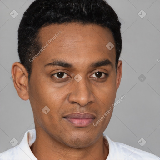 Joyful latino young-adult male with short  brown hair and brown eyes