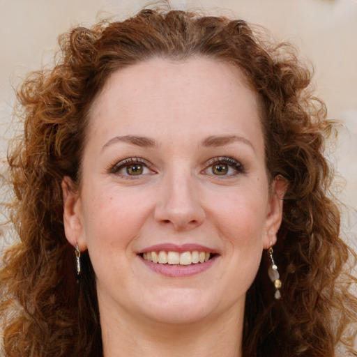 Joyful white young-adult female with long  brown hair and green eyes