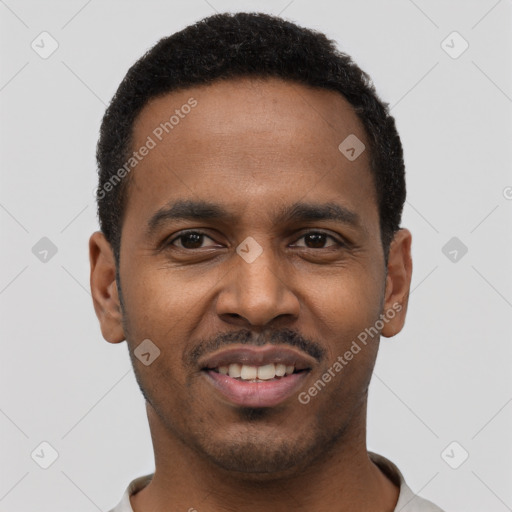 Joyful black young-adult male with short  black hair and brown eyes