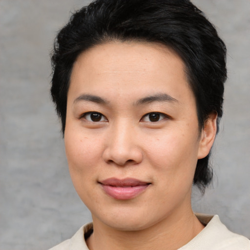 Joyful asian young-adult female with short  brown hair and brown eyes