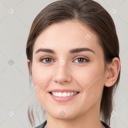 Joyful white young-adult female with medium  brown hair and grey eyes