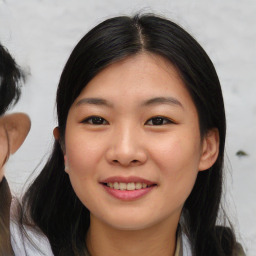 Joyful asian young-adult female with medium  black hair and brown eyes