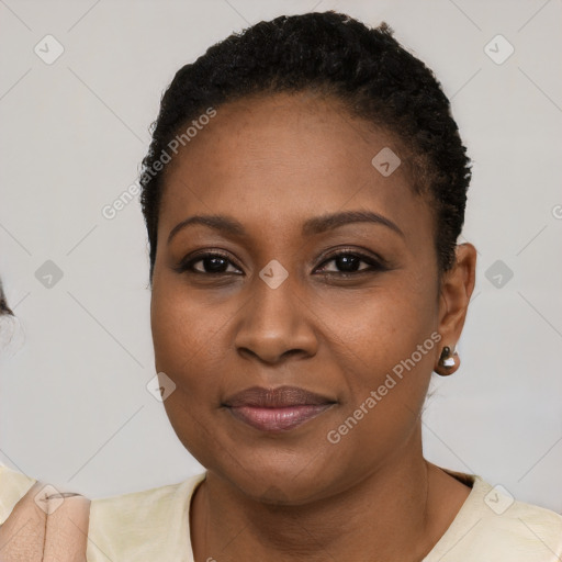 Joyful black young-adult female with short  black hair and brown eyes