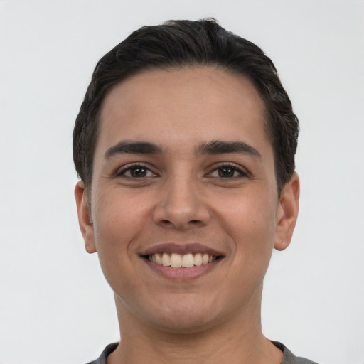 Joyful white young-adult male with short  black hair and brown eyes