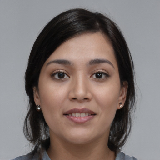 Joyful white young-adult female with medium  black hair and brown eyes
