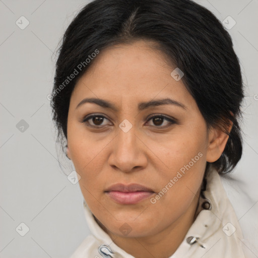 Joyful latino adult female with medium  brown hair and brown eyes