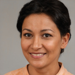 Joyful white adult female with medium  brown hair and brown eyes