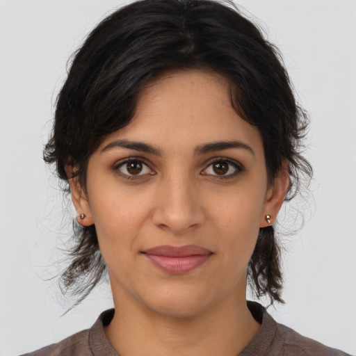Joyful latino young-adult female with medium  brown hair and brown eyes