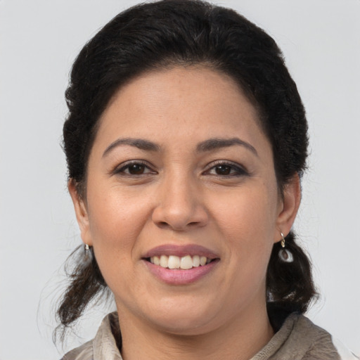 Joyful latino young-adult female with medium  brown hair and brown eyes