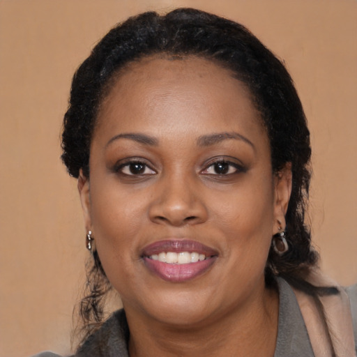 Joyful black adult female with medium  black hair and brown eyes