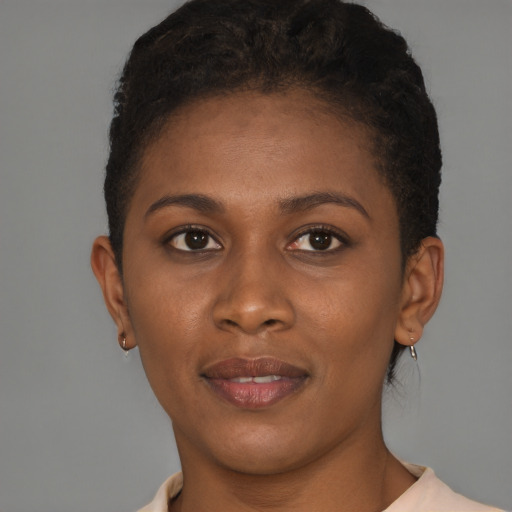 Joyful black young-adult female with short  brown hair and brown eyes