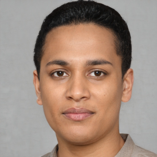 Joyful latino young-adult male with short  black hair and brown eyes
