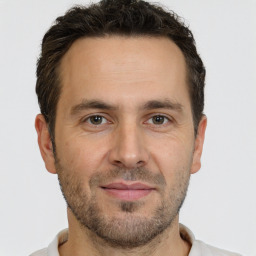 Joyful white adult male with short  brown hair and brown eyes