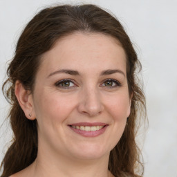 Joyful white young-adult female with medium  brown hair and green eyes