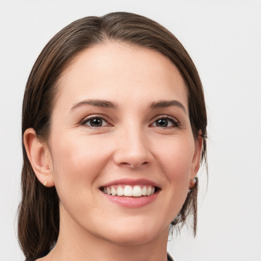 Joyful white young-adult female with medium  brown hair and grey eyes