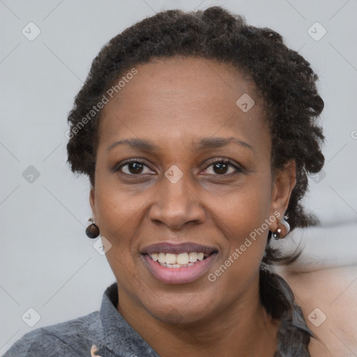 Joyful black adult female with short  brown hair and brown eyes