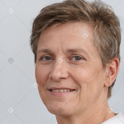 Joyful white adult female with short  brown hair and brown eyes