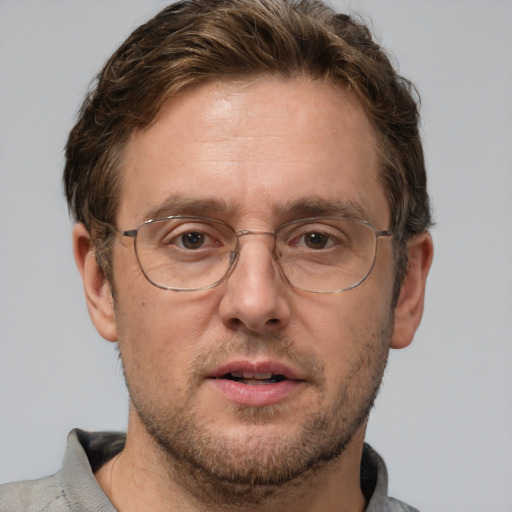 Joyful white adult male with short  brown hair and grey eyes