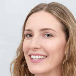 Joyful white young-adult female with long  brown hair and green eyes