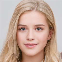 Joyful white young-adult female with long  brown hair and blue eyes